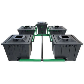 Alien professional-grade hydroponic system with multiple black pots arranged in a series, connected by pipes and fittings, with a green support structure.