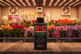 SMTC Concentrate Leaf Wash Eliminator bottle on a wooden table with flowers in the background