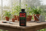SMC Concentrate bottle on a wooden table with plants in the background