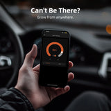 Hand holding a smartphone with app interface inside a car, with text 'Can't Be There? Grow from anywhere.'