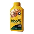 bloom yellow bottles ooze on white background