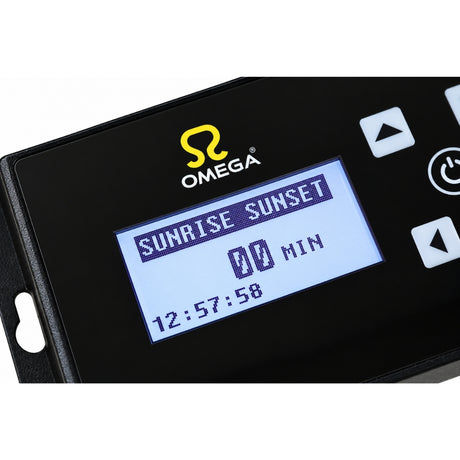 Close-up of a black Omega electronic controller with a blue backlit LCD screen showing 'SUNRISE SUNSET' and time settings, on a white background.